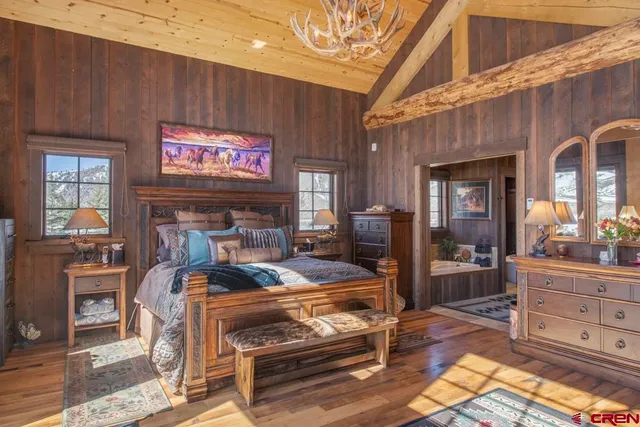 a large bedroom with a bed and a fireplace