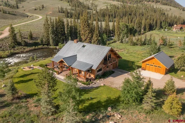 an aerial view of a house with yard