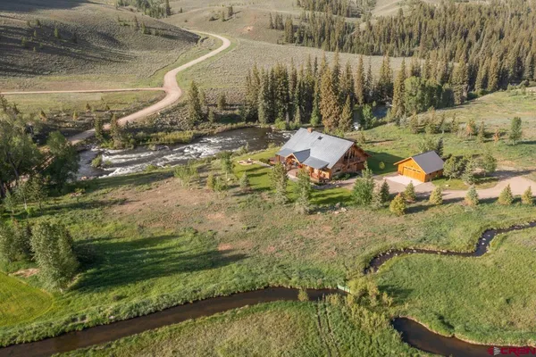 an aerial view of a house with a yard