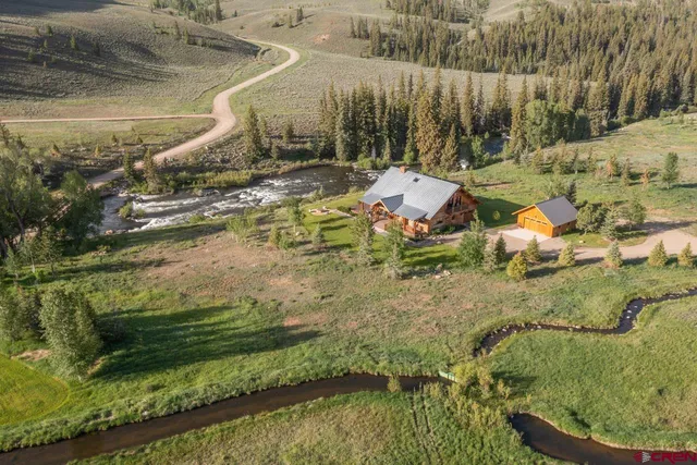 an aerial view of a house with a yard