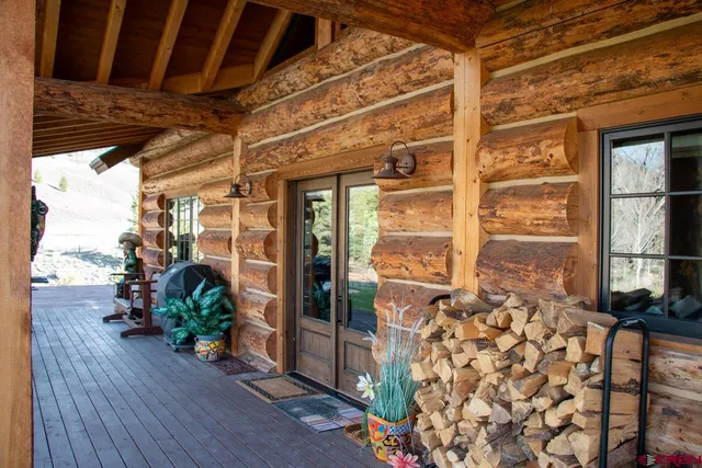 a building outdoor space with patio furniture and a fireplace