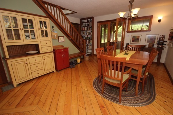 91 Long Hill Road Leverett, MA 01054 - Photo 14 of 29 a view of a dining room with furniture a chandelier and wooden floor