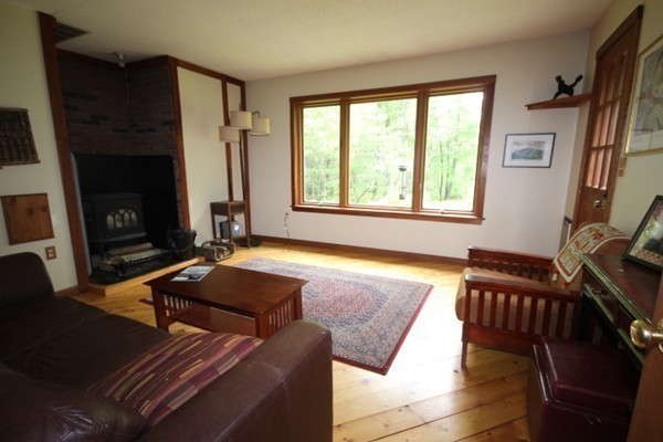 91 Long Hill Road Leverett, MA 01054 - Photo 19 of 29 a living room with furniture fireplace and a window