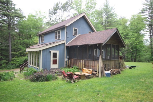 91 Long Hill Road Leverett, MA 01054 - Photo 4 of 29 a front view of a house with a yard table and chairs