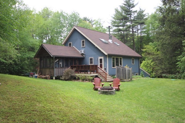 91 Long Hill Road Leverett, MA 01054 - Photo 5 of 29 a view of a house with a yard chairs and a patio