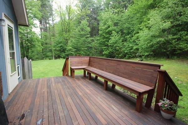 91 Long Hill Road Leverett, MA 01054 - Photo 7 of 29 a wooden bench sitting on top of a wooden deck