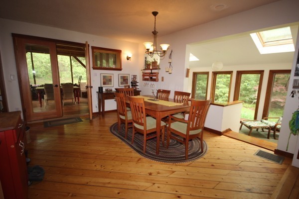 91 Long Hill Road Leverett, MA 01054 - Photo 8 of 29 a view of a dining room with furniture a chandelier and wooden floor