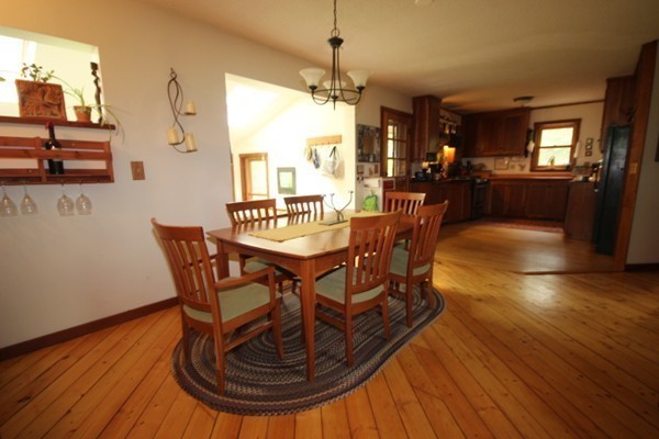 91 Long Hill Road Leverett, MA 01054 - Photo 10 of 29 a dining room with furniture a chandelier and wooden floor