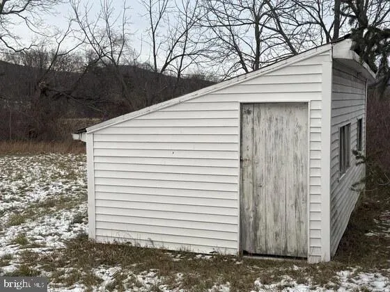 a view of a white house with a large tree