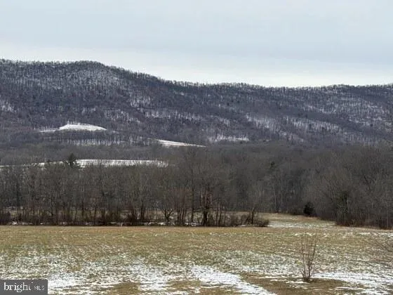 a view of a large body of water with a house in the background