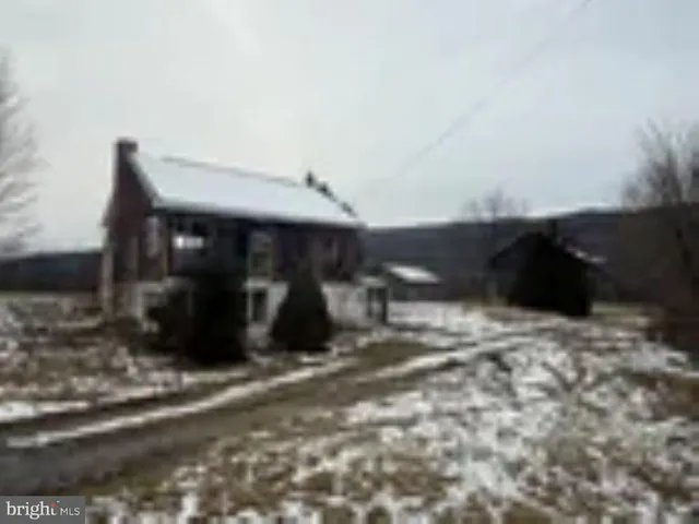 a view of a house with yard and wooden fence