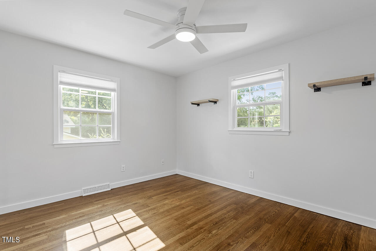 408 Latimer Road Raleigh, NC 27609 - Photo 11 of 19 a view of empty room with wooden floor and fan