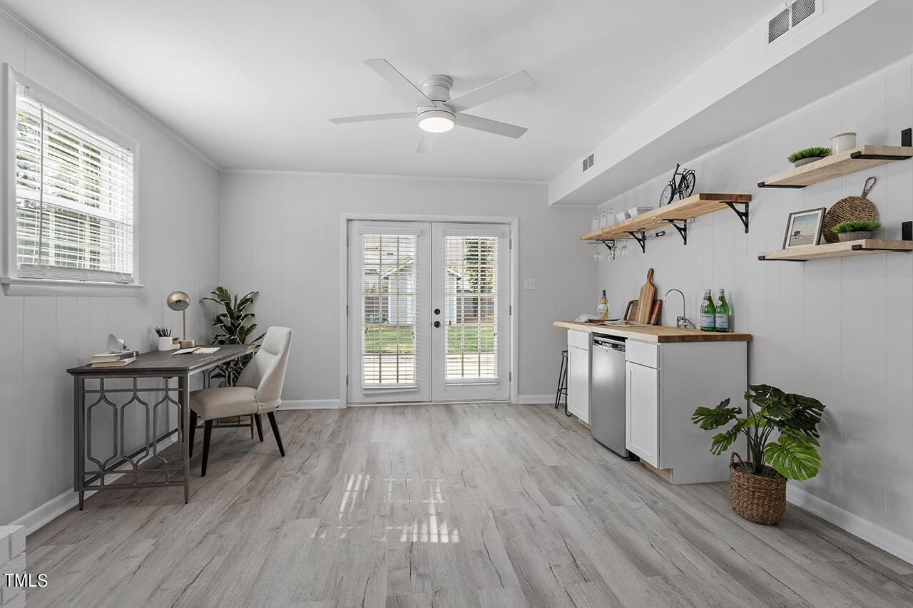 408 Latimer Road Raleigh, NC 27609 - Photo 13 of 19 a workspace with furniture wooden floor and a potted plant