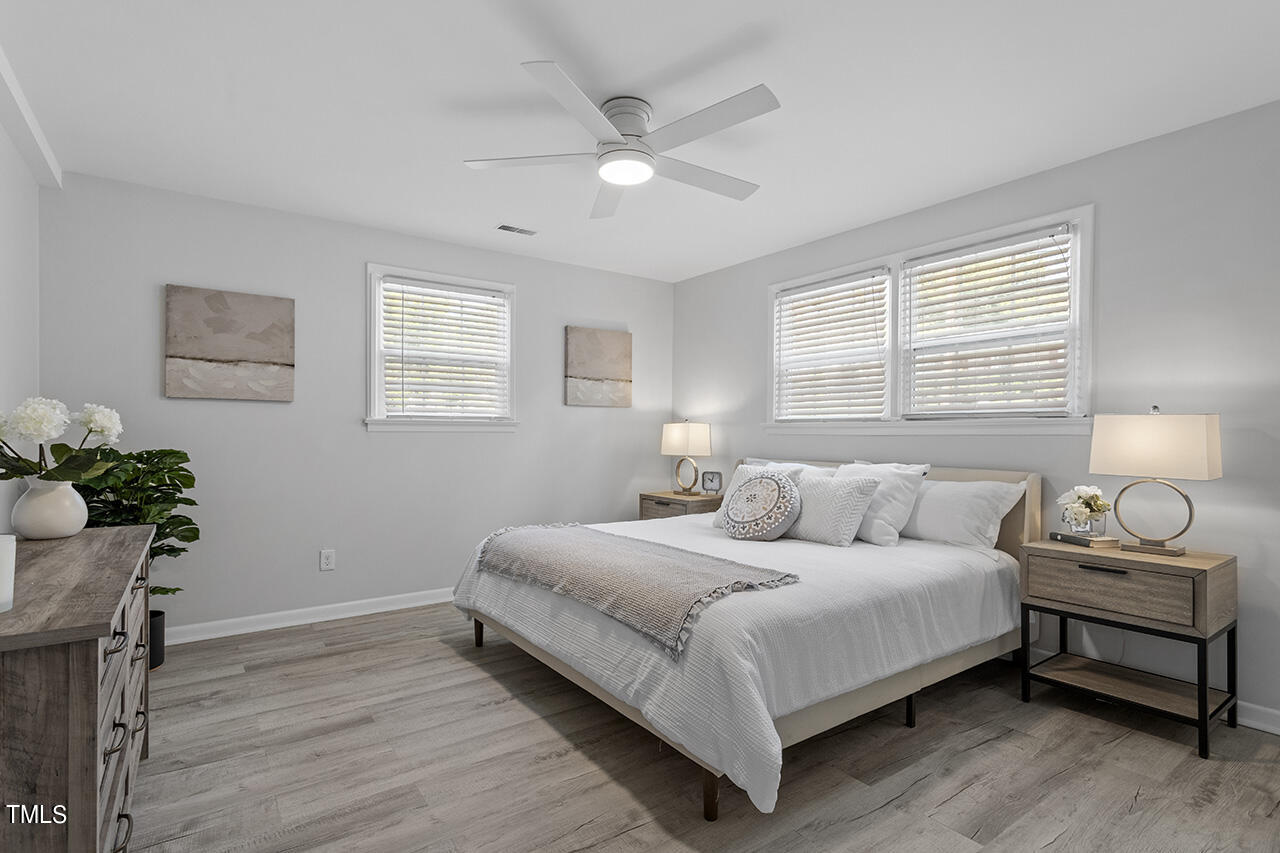 408 Latimer Road Raleigh, NC 27609 - Photo 15 of 19 a bedroom with a bed and a potted plant