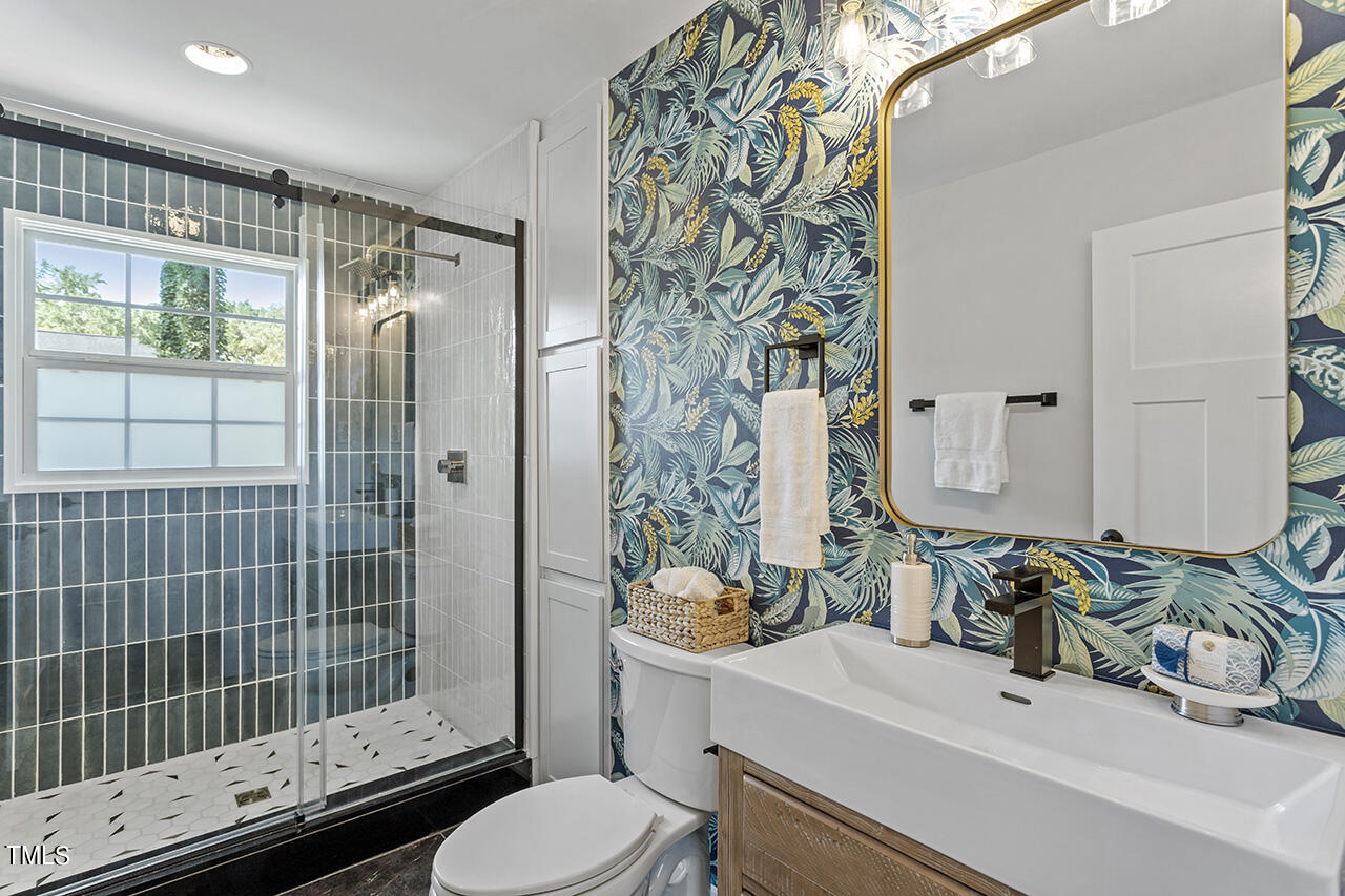 408 Latimer Road Raleigh, NC 27609 - Photo 9 of 19 a bathroom with a sink toilet and shower