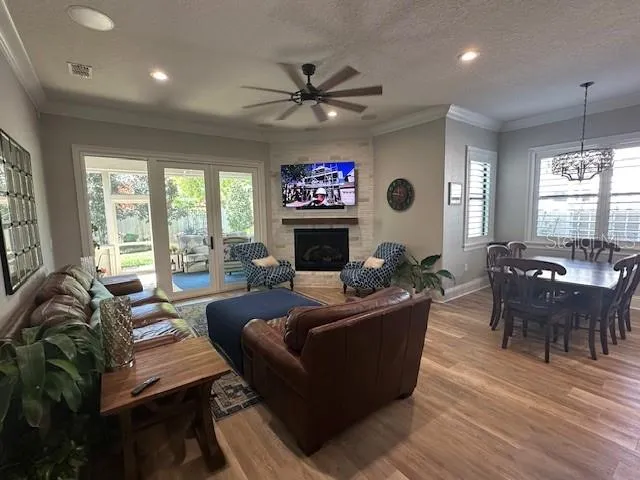 a living room with furniture a large window and a flat screen tv
