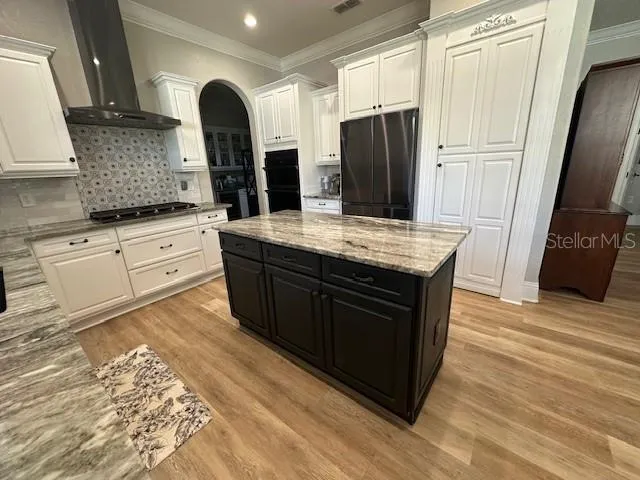 a kitchen with stainless steel appliances granite countertop a stove a refrigerator and a sink