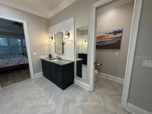 a large bathroom with a granite countertop sink a large mirror and a shower