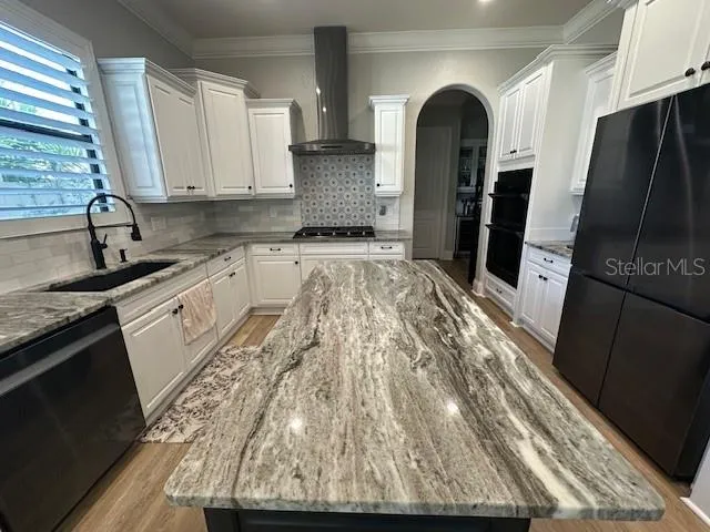 a kitchen with granite countertop a refrigerator and a stove