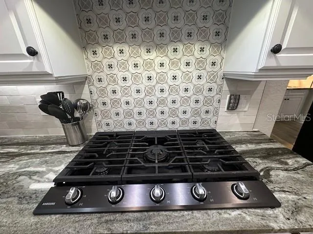 a stove sitting inside of a kitchen