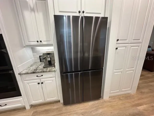 a kitchen with a refrigerator and cabinets