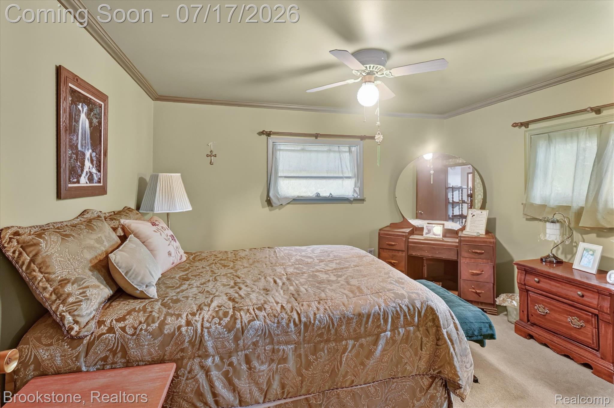 22025 Lakefield Road Merrill, MI 48637 - Photo 15 of 47 Carpeted room featuring a ceiling fan with integrated lighting, crown molding, and two windows