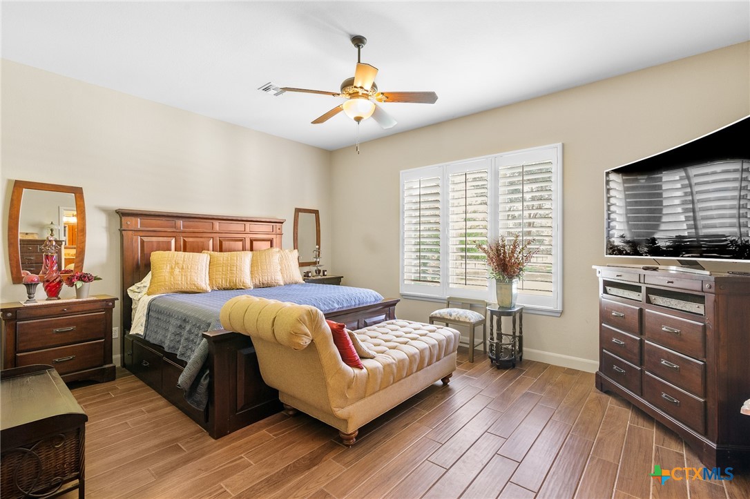 166 Post Oak Bend Inez, TX 77968 - Photo 17 of 48 a bedroom with a large bed and a flat tv screen on dresser