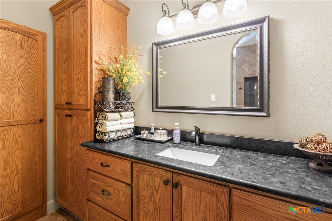 166 Post Oak Bend Inez, TX 77968 - Photo 19 of 48 a bathroom with a granite countertop sink and a mirror