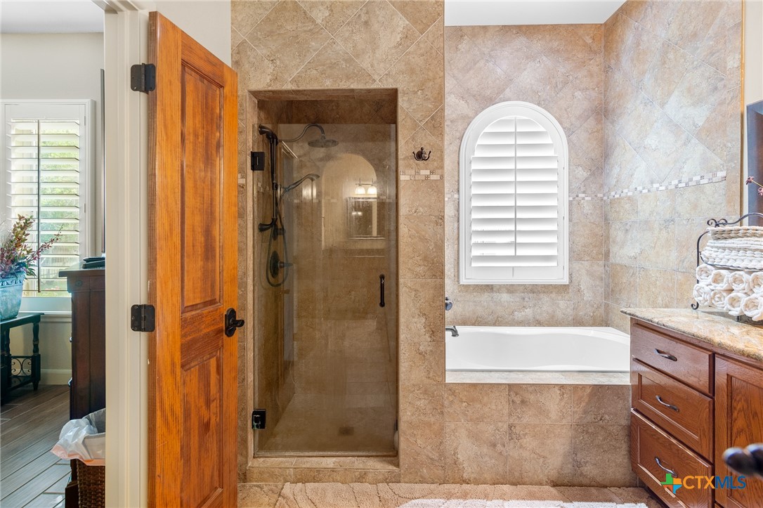 166 Post Oak Bend Inez, TX 77968 - Photo 20 of 48 a bathroom with a bathtub and a shower