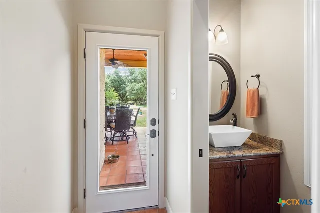 a view of a patio with table and chairs potted plants and a large tree
