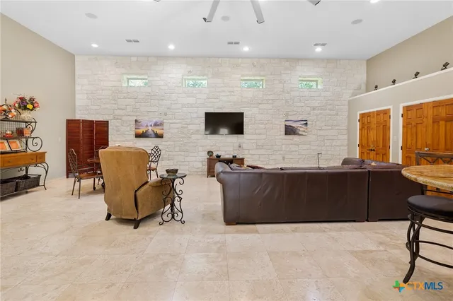 a kitchen with granite countertop a sink a stove and cabinets