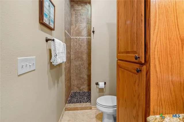 a bathroom with a granite countertop sink vanity and mirror