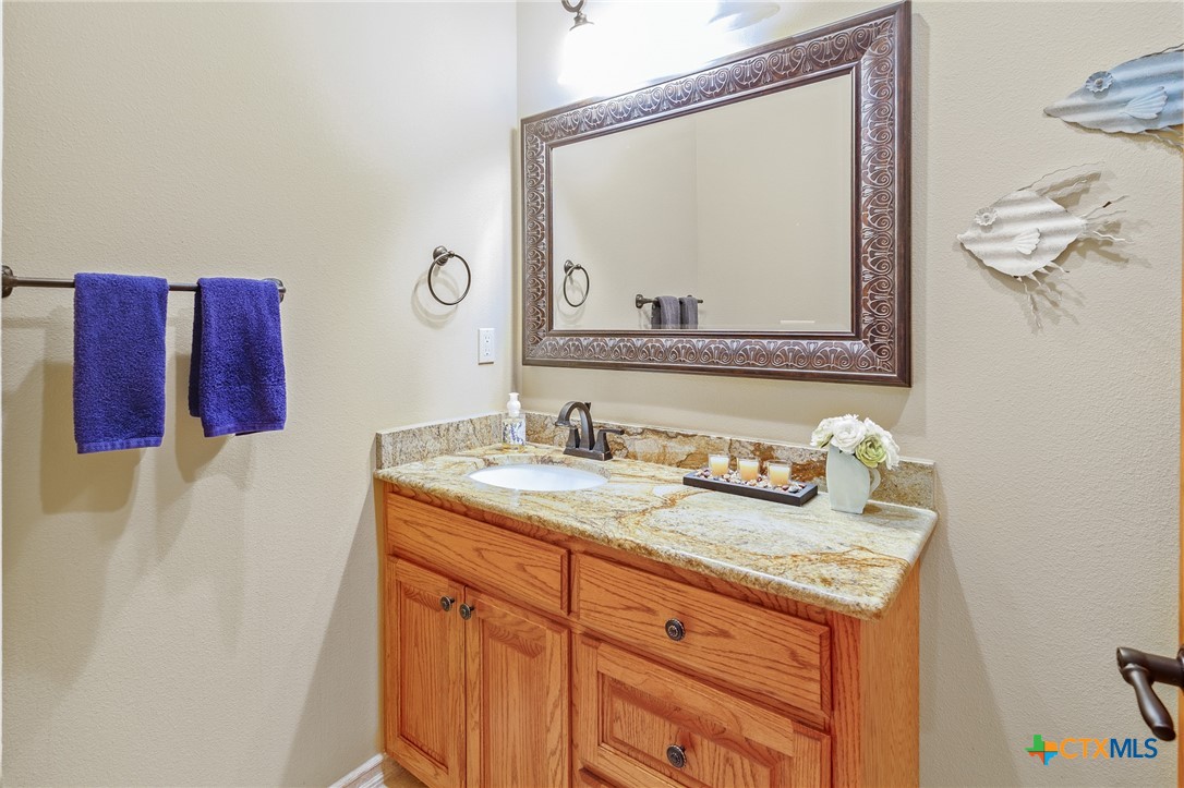 166 Post Oak Bend Inez, TX 77968 - Photo 41 of 48 a bathroom with a granite countertop sink vanity and mirror