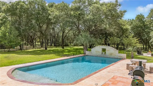 an aerial view of a house with a yard and outdoor seating