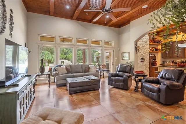 a kitchen with stainless steel appliances granite countertop a sink a stove and refrigerator