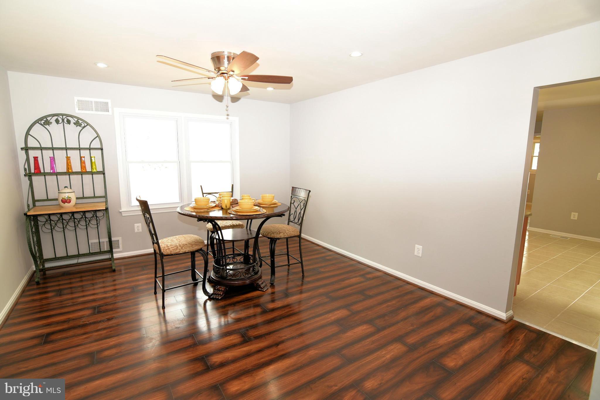 6504 Springbrook Lane Clinton, MD 20735 - Photo 11 of 30 a view of a dining room with furniture and wooden floor