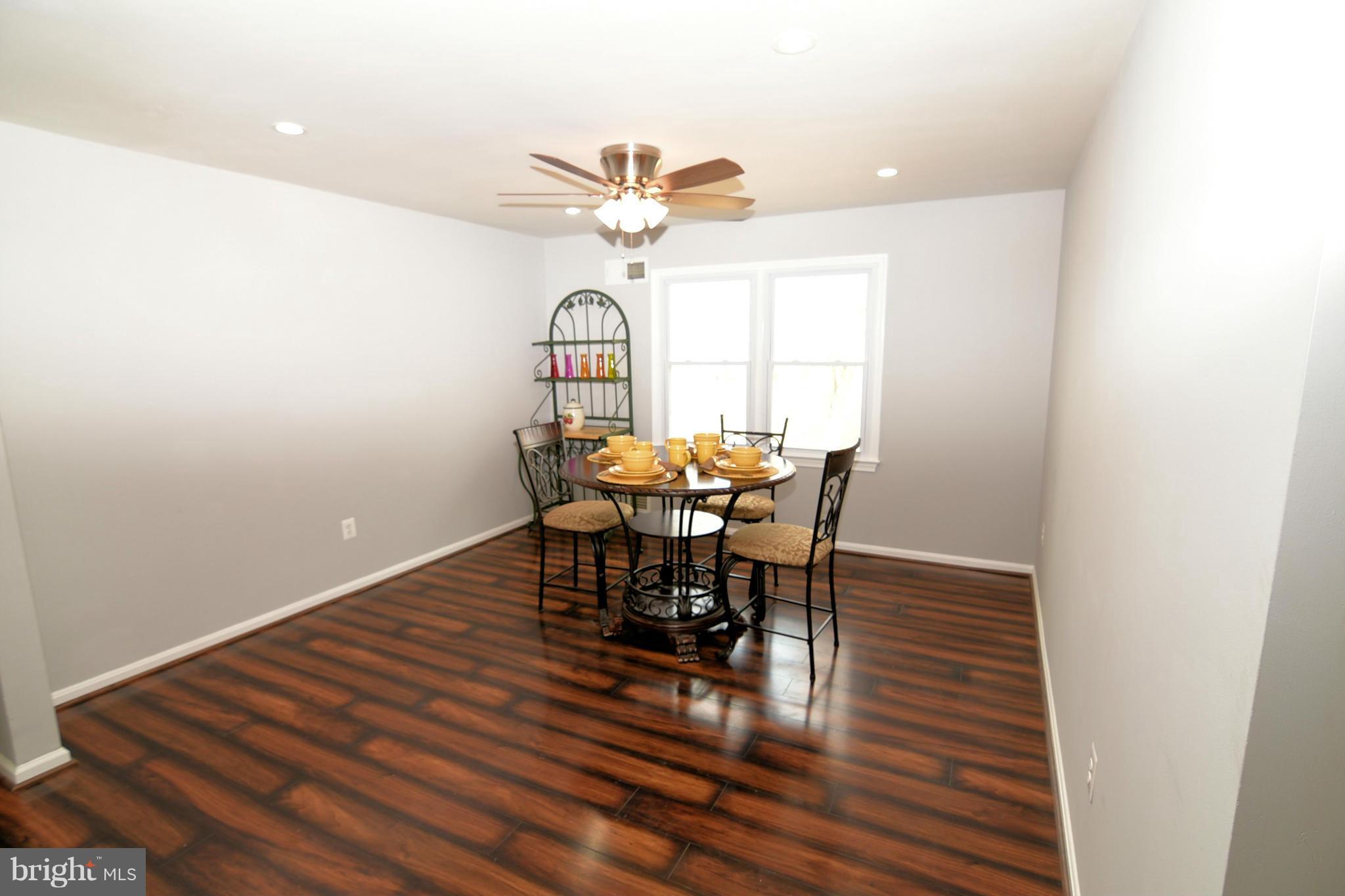 6504 Springbrook Lane Clinton, MD 20735 - Photo 12 of 30 a view of a dining room with furniture and a chandelier