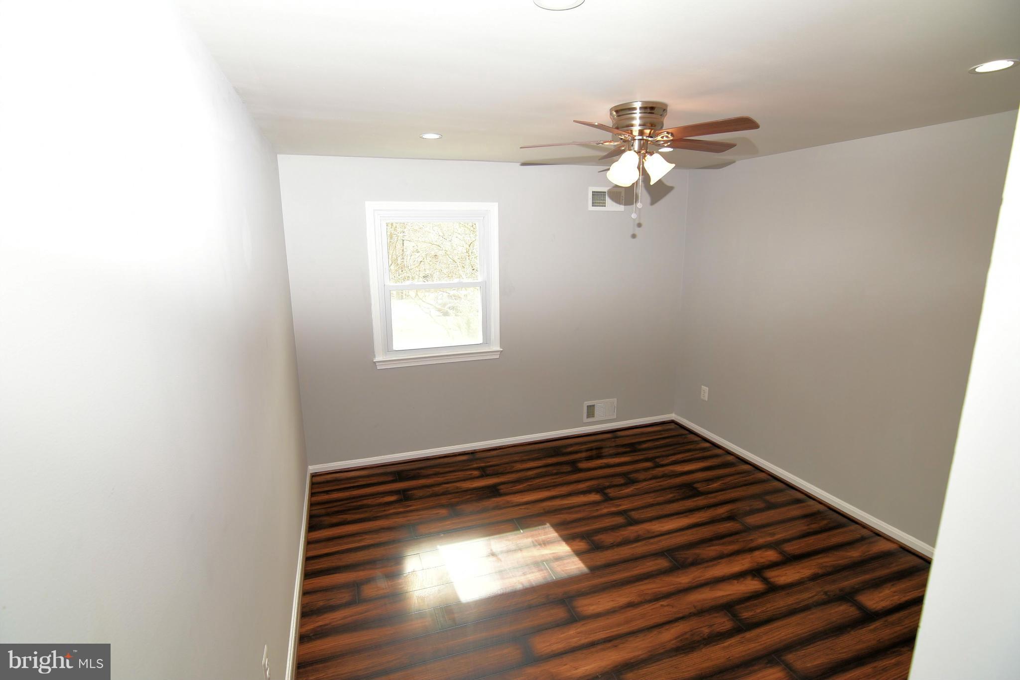 6504 Springbrook Lane Clinton, MD 20735 - Photo 15 of 30 a view of room with hardwood floor and ceiling fan