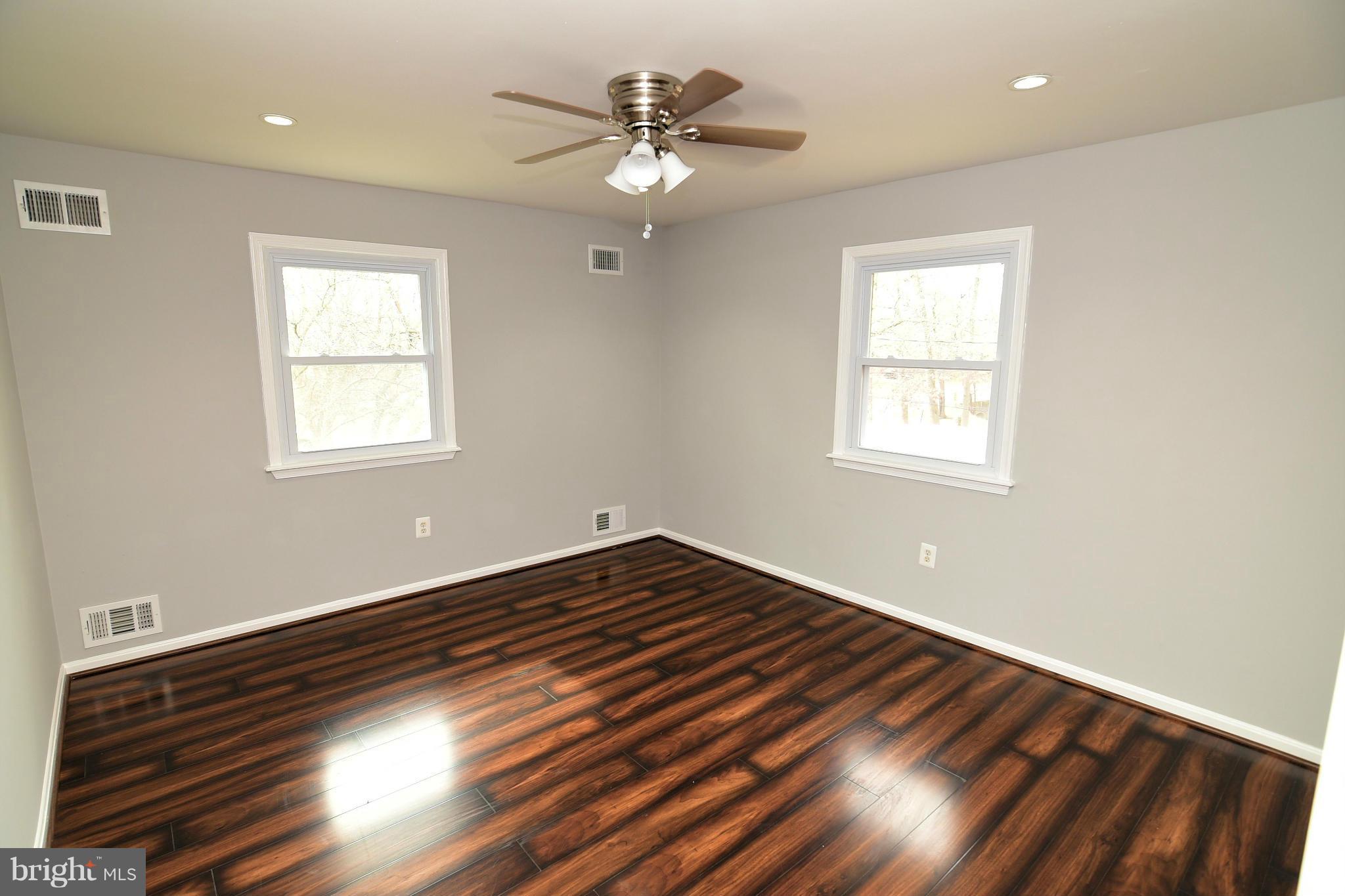 6504 Springbrook Lane Clinton, MD 20735 - Photo 16 of 30 a view of an empty room with wooden floor and a window