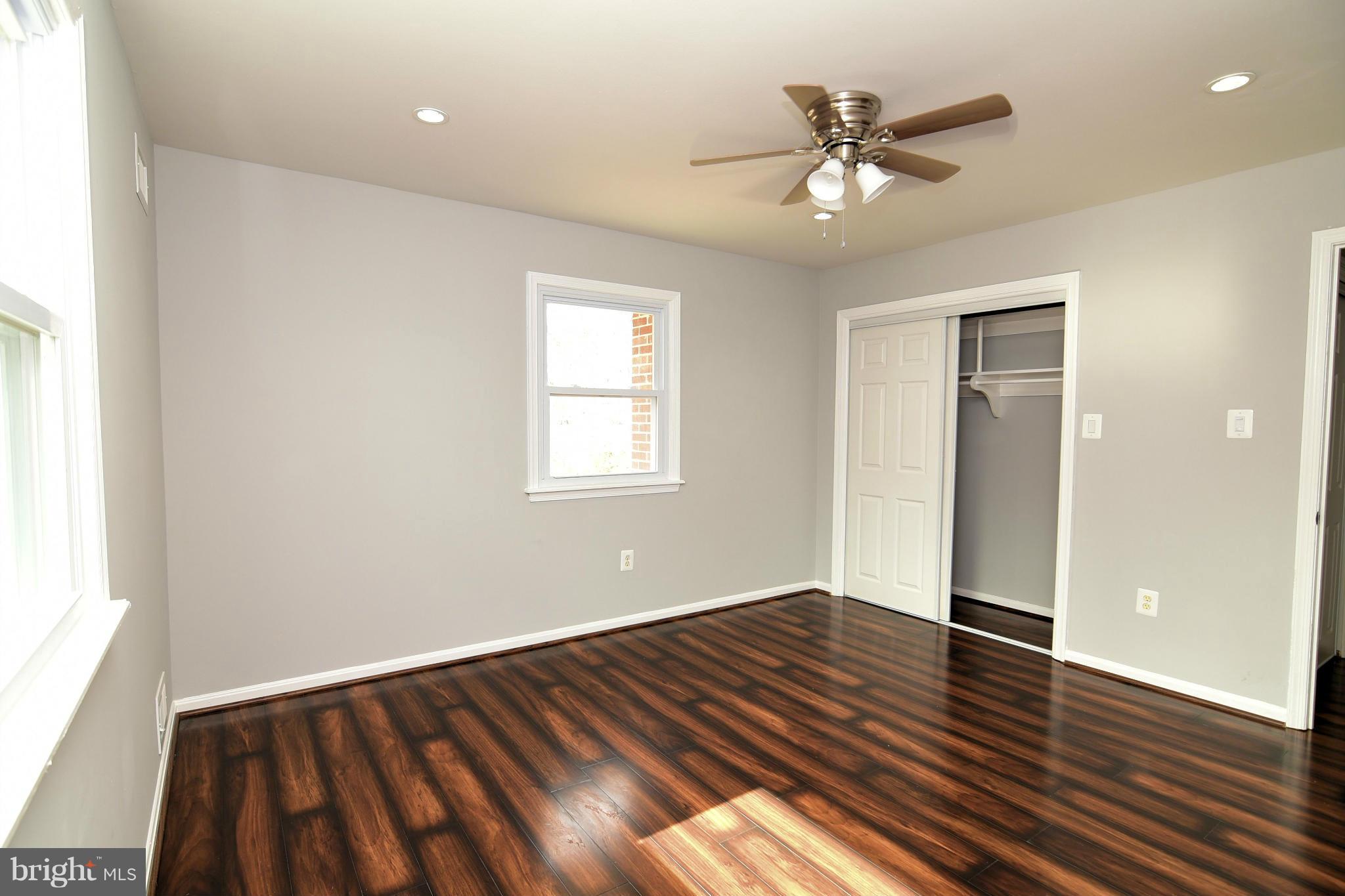 6504 Springbrook Lane Clinton, MD 20735 - Photo 17 of 30 an empty room with wooden floor and windows
