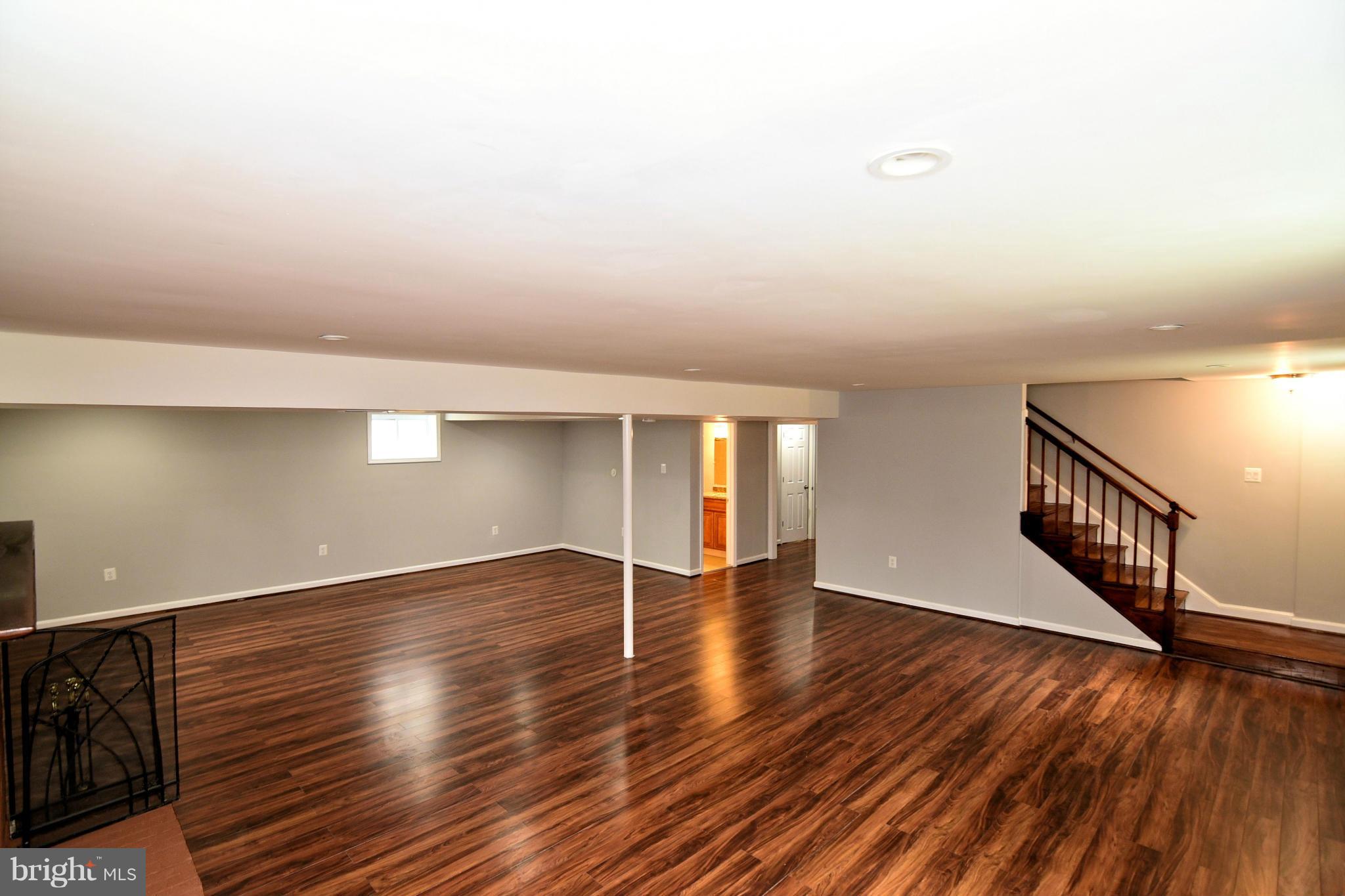 6504 Springbrook Lane Clinton, MD 20735 - Photo 23 of 30 a view of an empty room with wooden floor and a window
