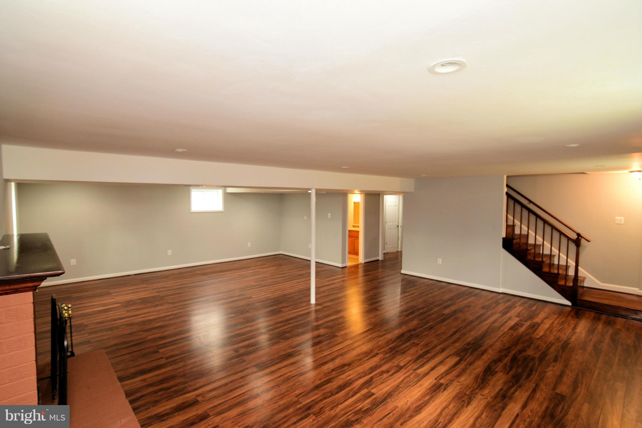 6504 Springbrook Lane Clinton, MD 20735 - Photo 24 of 30 a view of an empty room with wooden floor and a window