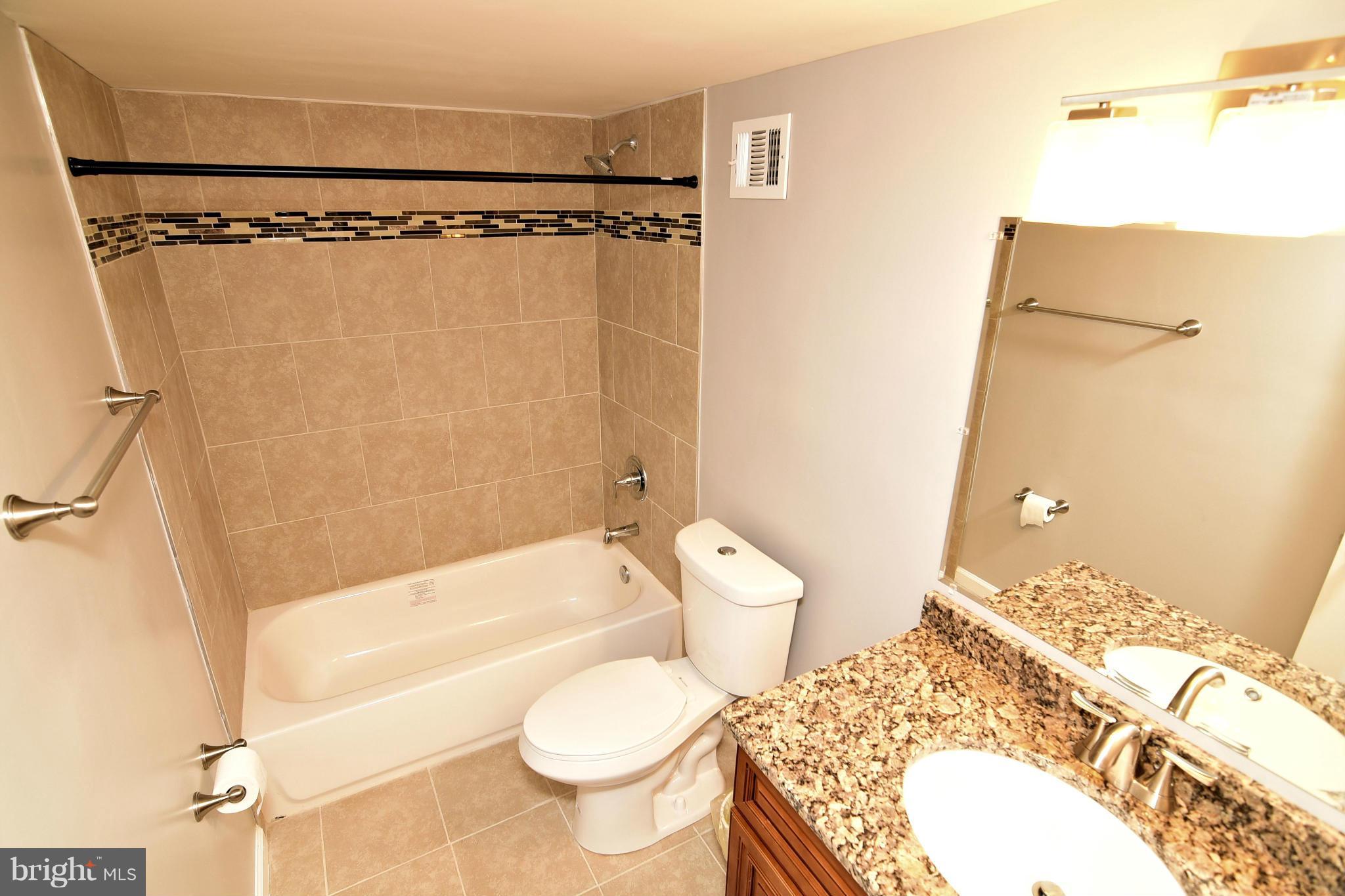 6504 Springbrook Lane Clinton, MD 20735 - Photo 25 of 30 a bathroom with a sink toilet and shower