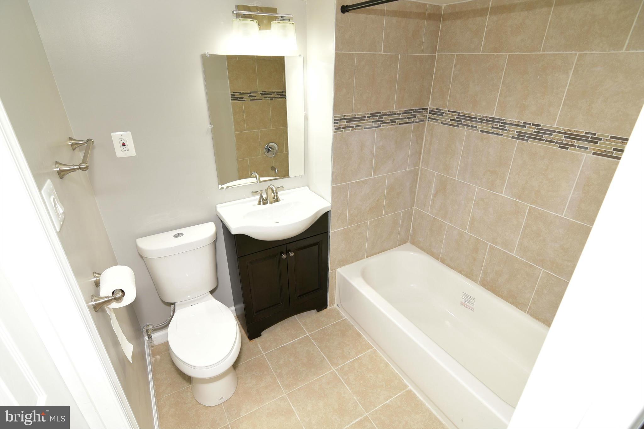 6504 Springbrook Lane Clinton, MD 20735 - Photo 28 of 30 a bathroom with a sink a toilet and shower