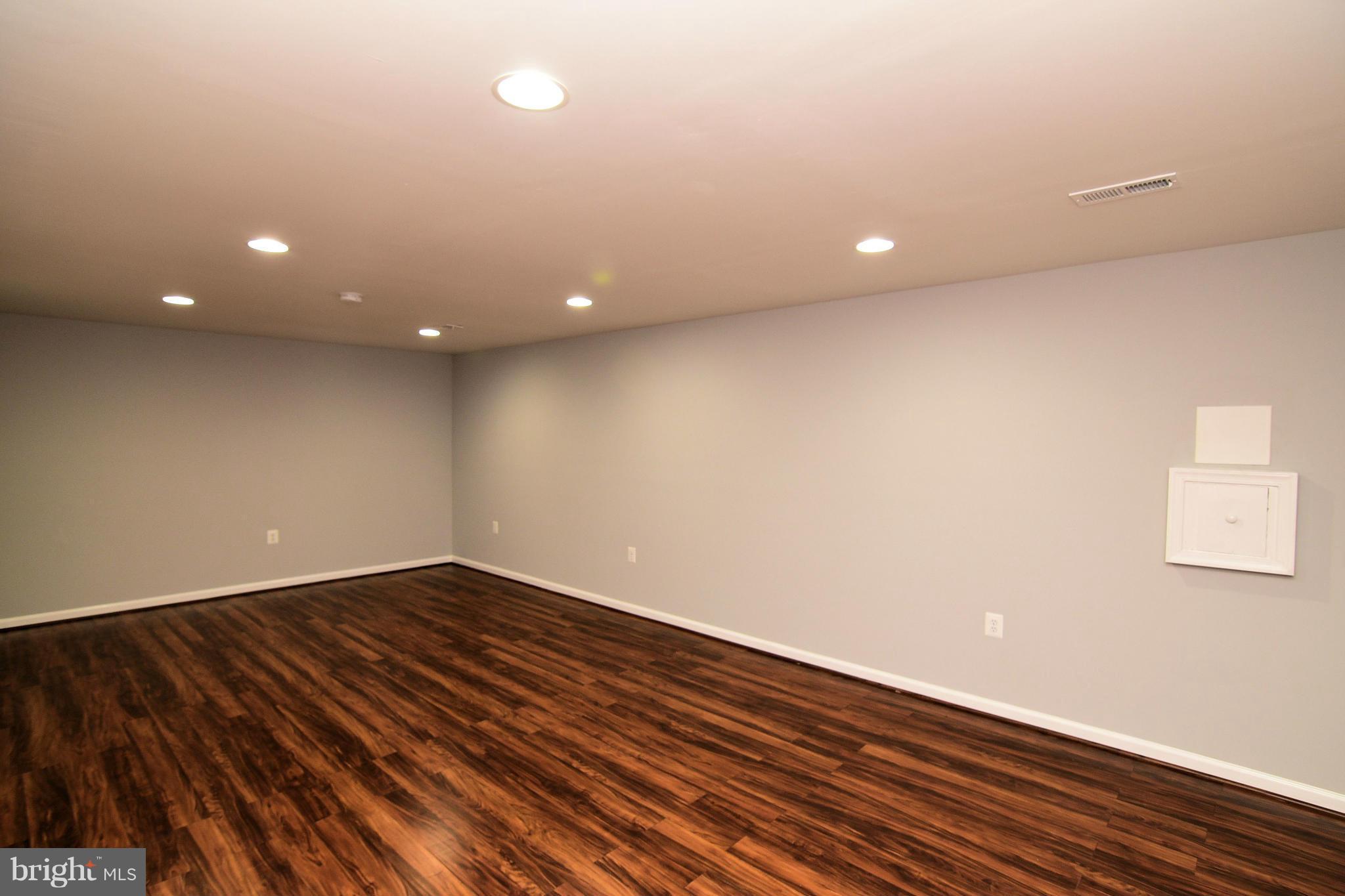 6504 Springbrook Lane Clinton, MD 20735 - Photo 30 of 30 a view of an empty room with wooden floor and a window