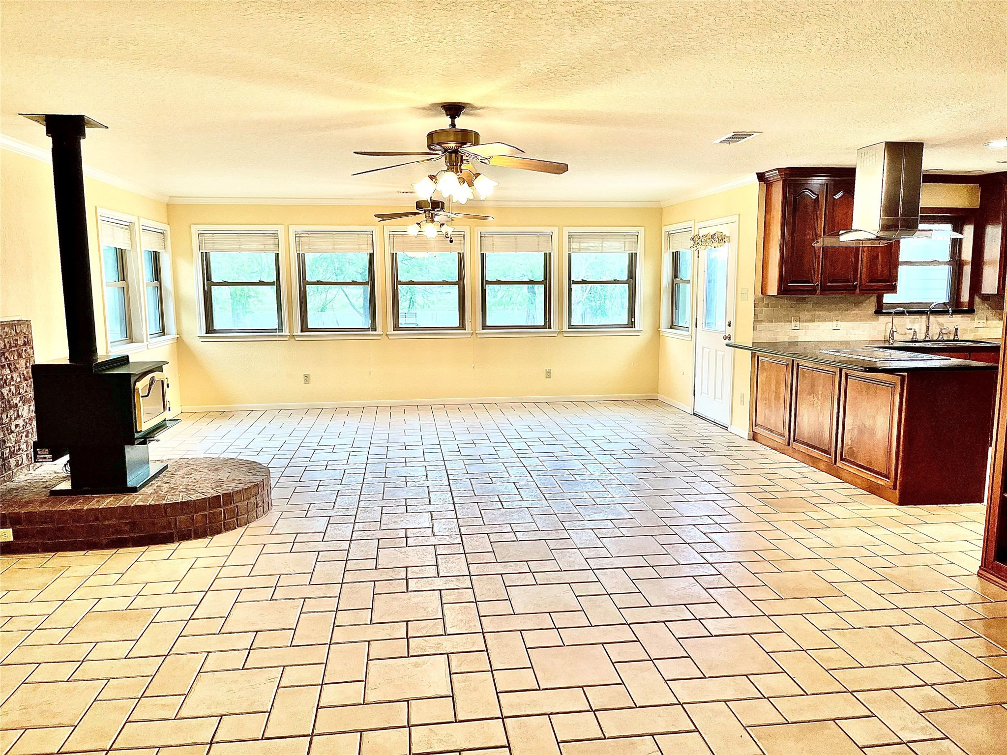 37243 FM 521 Road Bay City, TX 77414 - Photo 10 of 50 The spacious living area features a great view of Cannon Lake! This room features a modern wood stove for ambience and an additional source for home heating. The low-maintenance tile flooring and ceiling fans are a plus!