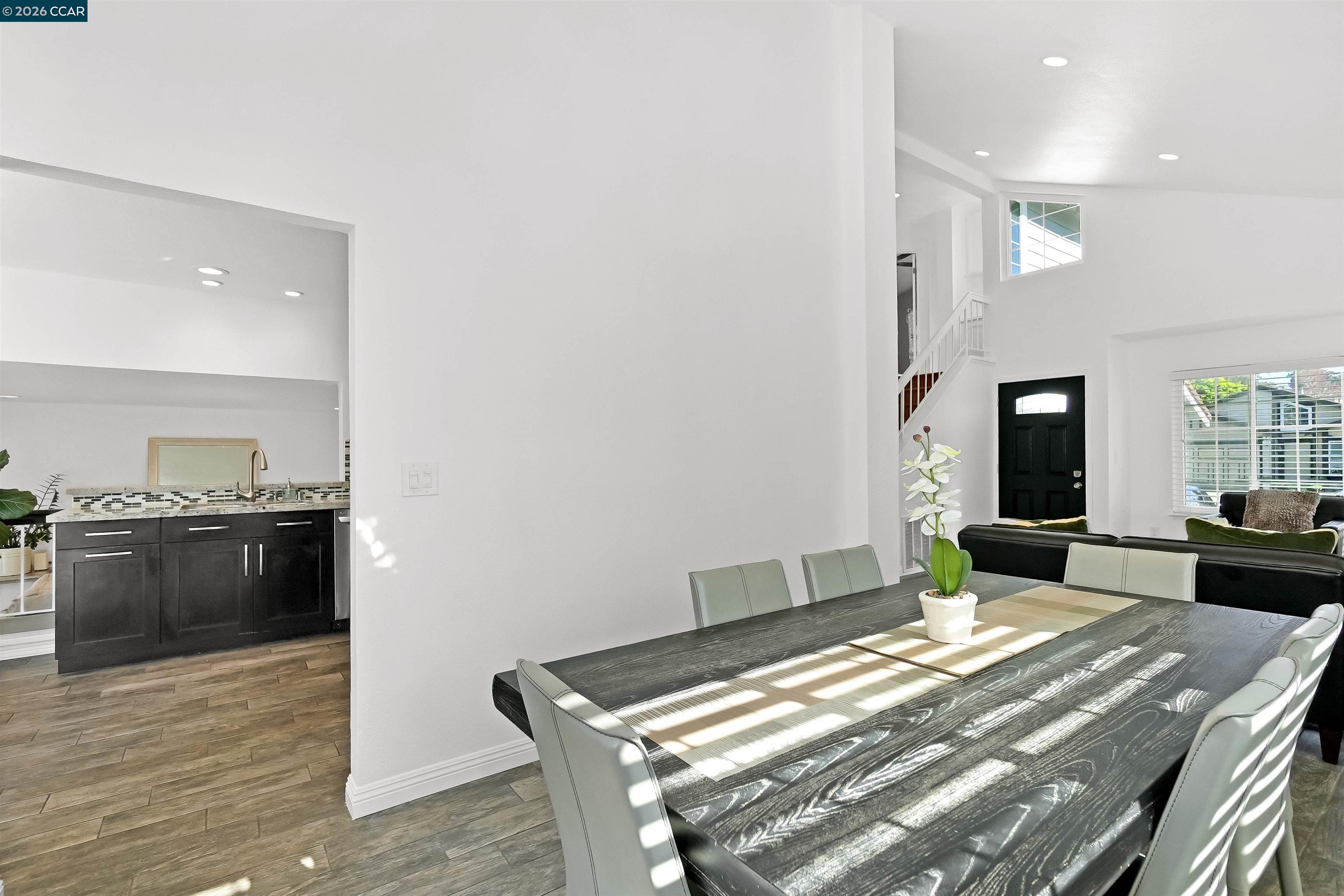 162 Woodfield Hercules, CA 94547 - Photo 13 of 59 a living room with kitchen island granite countertop furniture and wooden floor