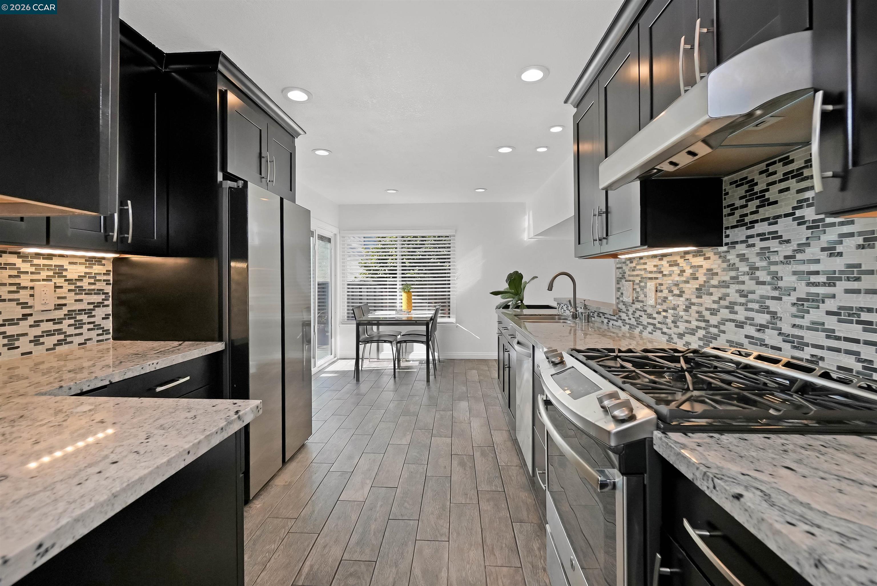 162 Woodfield Hercules, CA 94547 - Photo 14 of 59 a kitchen with granite countertop stainless steel appliances and wooden cabinets