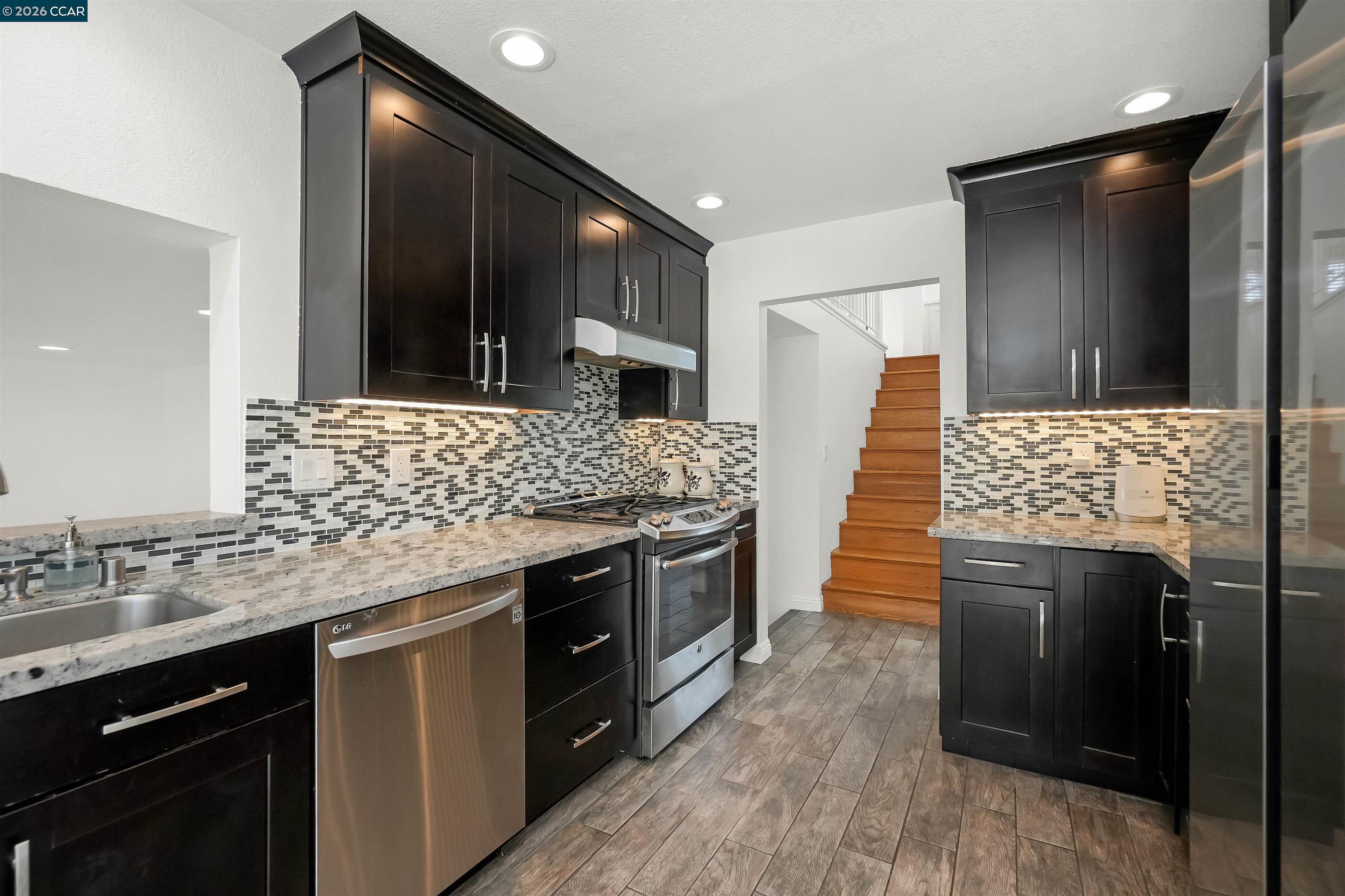 162 Woodfield Hercules, CA 94547 - Photo 15 of 59 a kitchen with stainless steel appliances wooden cabinets and granite counter tops