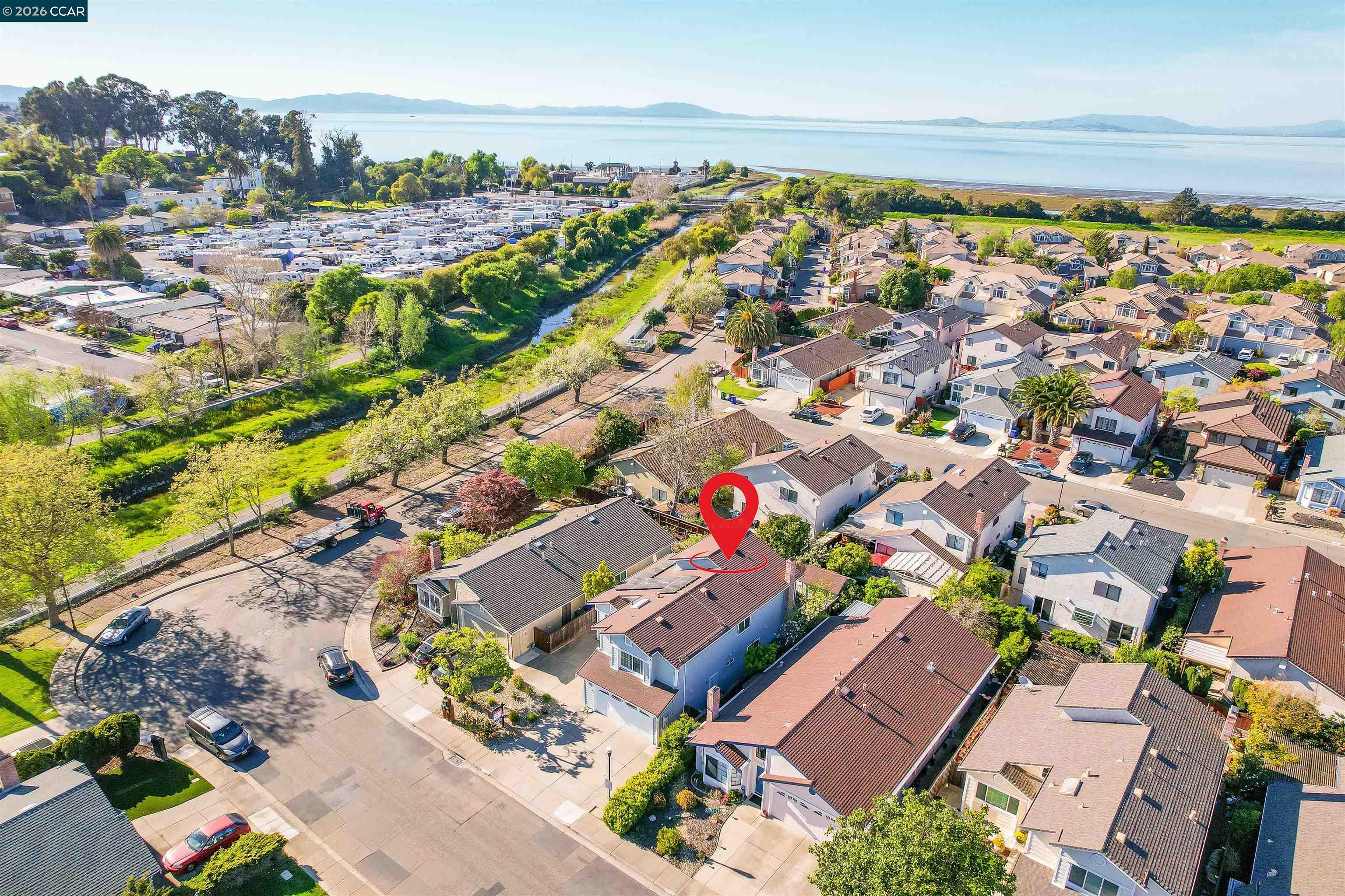 162 Woodfield Hercules, CA 94547 - Photo 50 of 59 an aerial view of a city with lots of residential buildings and ocean view in back
